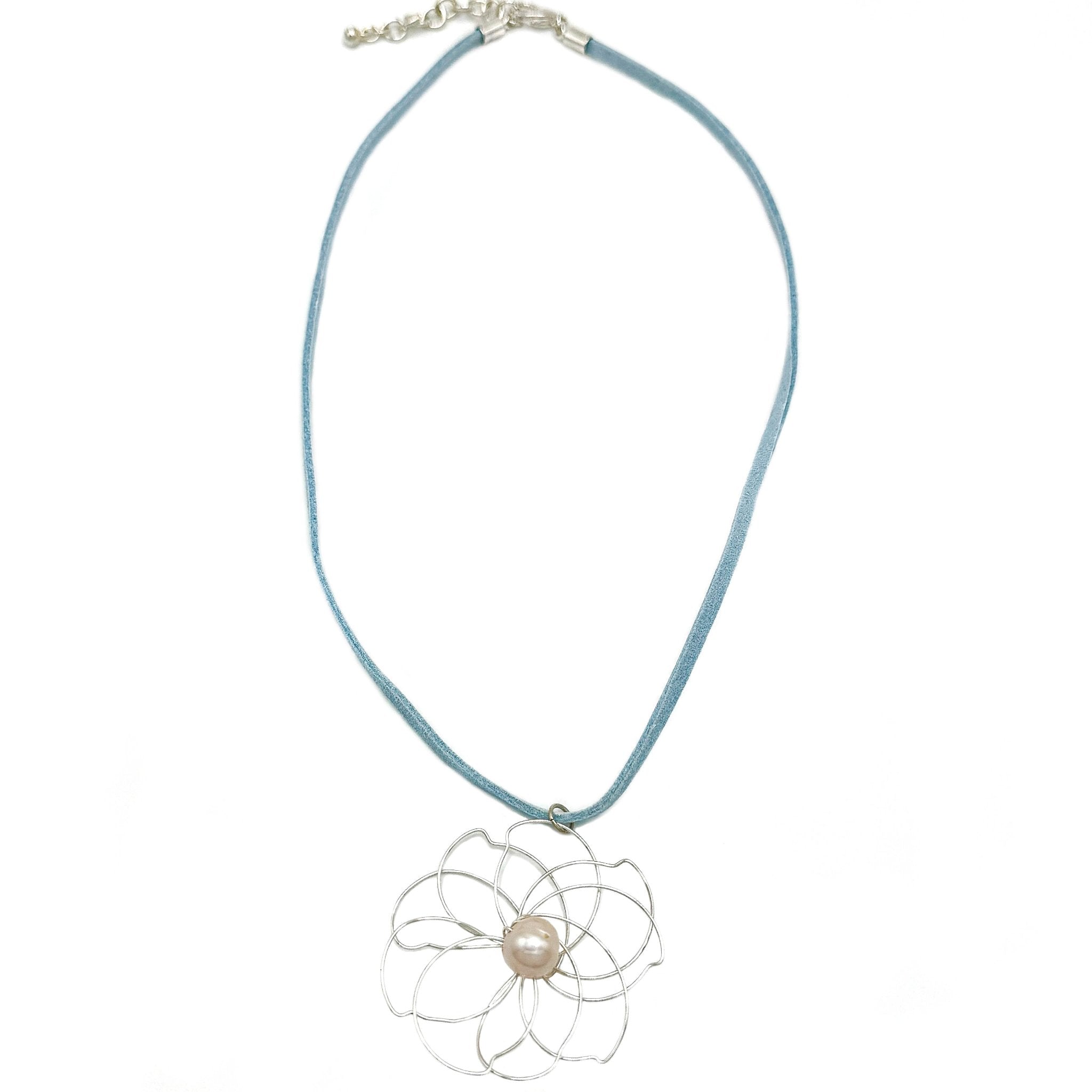 Petals silver flower and pearl pendant on a blue suede necklace