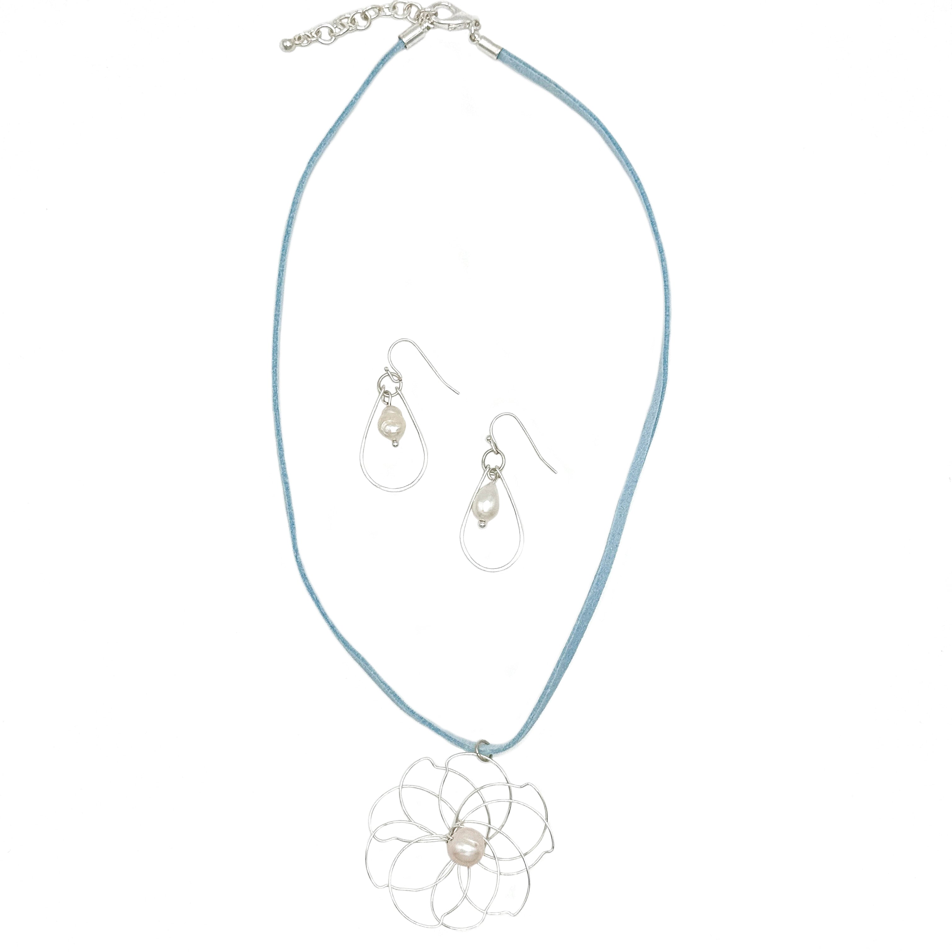 Petals silver flower and pearl pendant on a blue suede necklace